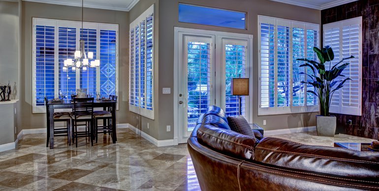 Clearwater great room with white shutters and tile floor.